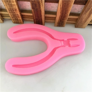 Pink silicone mold shaped like pliers for DIY fondant cake decoration and plaster crafts