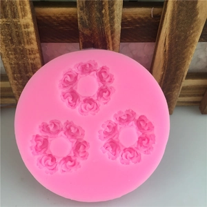 Pink 3D silicone mold with three detailed rose patterns for fondant and cake decorating