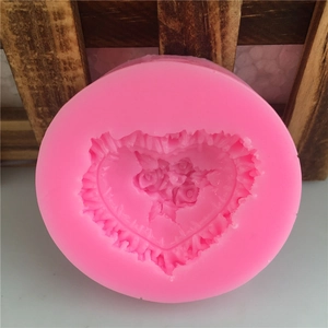Pink heart-shaped silicone mold with rose flower carving for fondant and chocolate baking