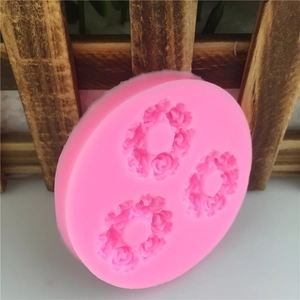 Pink silicone mold featuring three detailed 3D rose designs for cake fondant and chocolate