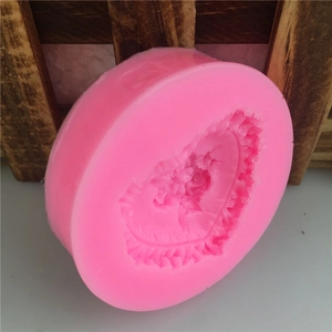 Pink silicone fondant mold featuring heart-shaped rose lace design for DIY baking