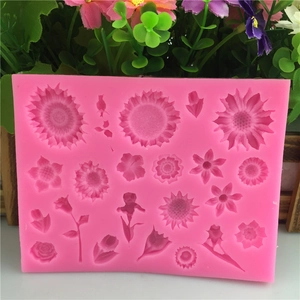 Pink silicone fondant mold with various flower and leaf shapes for cake decorating