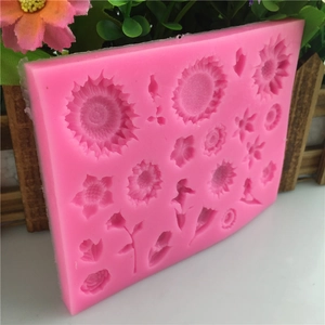 Pink silicone flower mold for fondant cake decorating with sunflowers and daisies