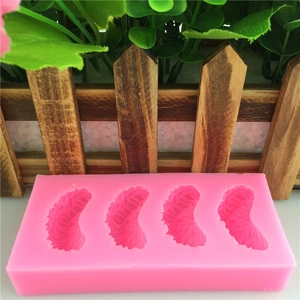 Pink silicone mold featuring four orange segment shapes for DIY fondant and cake baking