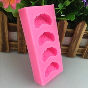 Detail of 4-cavity pink silicone mold showing realistic orange segment texture for cakes