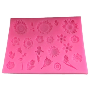 Pink silicone mold featuring multiple floral patterns like sunflower, tulip, and rose shapes