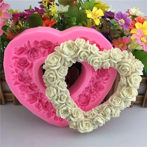 Pink heart-shaped silicone mold with rose flower texture for handmade soaps and fondant cakes