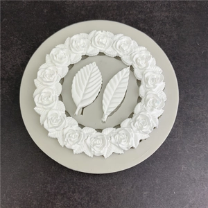 Silicone mold for rose wreath and leaves fondant cake decoration on grey surface