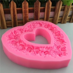 Pink heart-shaped silicone mold with rose floral pattern for DIY handmade cake decorating