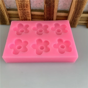 Pink 6-cavity silicone mold with mini 5-petal flower shapes for DIY chocolate and crafts