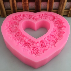 Pink heart-shaped silicone mold with floral rose patterns for DIY handmade cake decorating