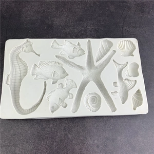 White silicone marine life mold featuring seahorse, starfish, and shells for cake decorating
