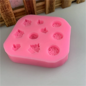 Pink silicone mold for mini cupcakes and hearts featuring 9 unique baking cavities