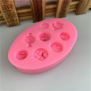 Detail of pink silicone mold featuring lollipop and cupcake shapes for DIY fondant