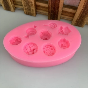 Close-up of pink silicone mold featuring heart, lollipop, and cupcake shapes for DIY crafts