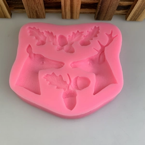 Pink silicone mold featuring reindeer and acorns for Christmas cake decorating and DIY