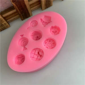 Pink silicone mold with miniature lollipop and cupcake shapes for DIY fondant and clay