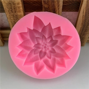 Detail showing round pink silicone mold with 3D floral petals for fondant and DIY crafts