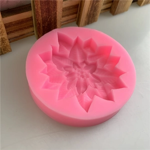 Pink silicone mold with detailed poinsettia flower design for fondant and chocolate cake decoration
