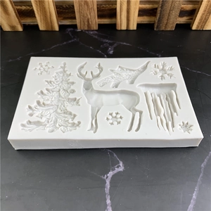 White silicone Christmas fondant mold with cedar, elk, and snowflake shapes for DIY baking