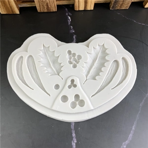 White holly leaf silicone mold for fondant and chocolate baking decoration on dark background