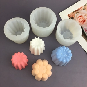 Detailed view of silicone molds and finished multi-colored wax canelé and flower shapes