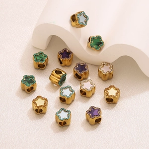 Macro shot of 18K gold plated star-shaped charms with colorful crystals for DIY jewelry making