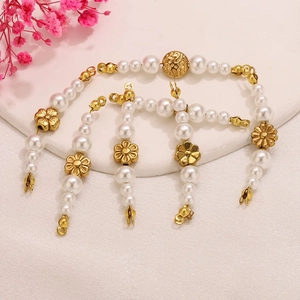 Vintage floral pearl necklace set with stainless steel accents on a round display board