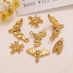 Macro detail of 18K gold plated bat, spider, and cicada charms for DIY jewelry crafting