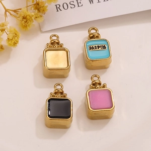 Macro shot of colorful stainless steel perfume bottle pendants with enamel and bow details