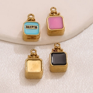 Detailed macro view of colorful perfume bottle pendants on white silk with PARFYM engraving
