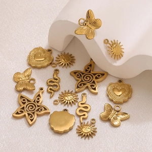 Detail of gold-plated stainless steel charms including butterfly and sun for DIY jewelry