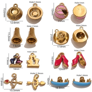 Assorted stainless steel DIY pendants including pink cake and gold charms for jewelry making