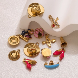 Detailed macro view of assorted gold-plated DIY jewelry pendants with colorful enamel charms