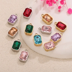 Macro view of colorful rectangular glass pendants in gold and silver stainless steel frames