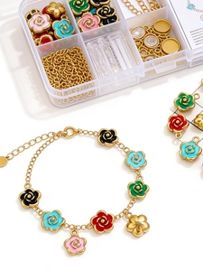 Macro detail of multi-colored enamel camellia charms on a gold bracelet kit