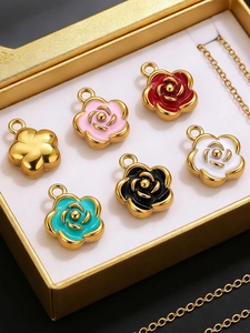 Detail of colorful enamel camellia flower pendants in a golden jewelry display box