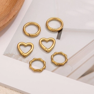 Detailed set of golden heart and round spring clasps for jewelry and bag accessories