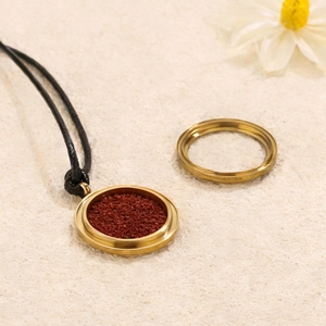 Golden stainless steel locket pendant with cinnabar stone inlay and matching ring set