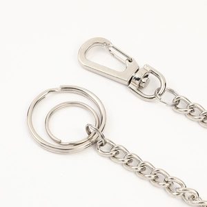 Detailed macro view of silver punk pants chain with lobster clasp and metal key rings