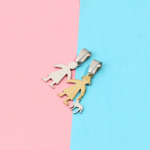 Detailed view of polished gold and silver family character pendants on a split colored background