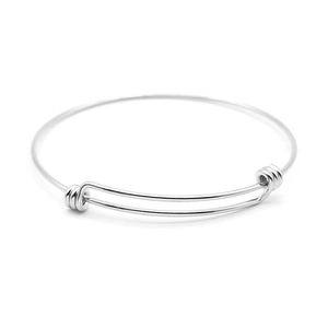 Adjustable stainless steel wire bangle with expandable coil closure on white background