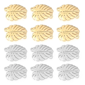 Macro detail of monstera leaf charms in gold and silver finish for DIY jewelry