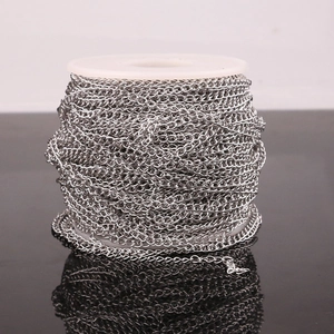 Polished stainless steel chain roll for DIY jewelry making on white plastic spool