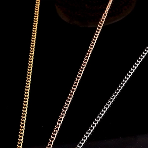 Macro shot of stainless steel extender chains in gold, rose gold and silver finishes