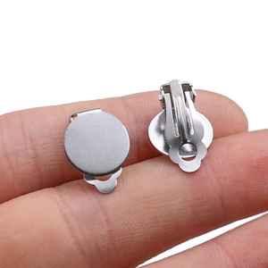 Detailed view of silver DIY earring clip bases held by hand for jewelry making