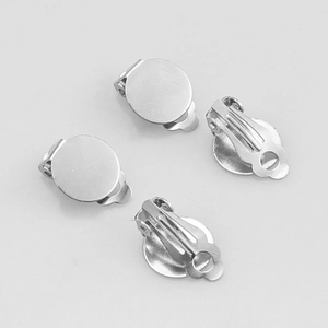 Macro top view of four silver stainless steel round base ear clip components for DIY jewelry