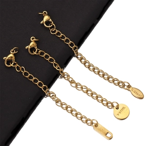 Detailed macro view of three 5cm gold-plated stainless steel extension chains on black leather