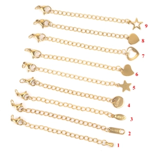 Golden 5cm stainless steel extender chains with lobster clasps and various pendants