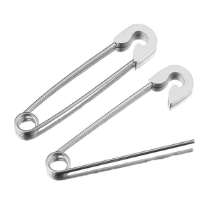 Polished stainless steel safety pins for clothing and DIY accessories on white surface
